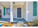 Inviting front entrance with green shutters and storm door at 306 Andorra St., Longs, SC 29568