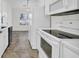 Clean white kitchen with tile floors and modern appliances at 306 Andorra St., Longs, SC 29568