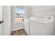 Bright laundry room with washer, dryer, and ample shelving at 306 Andorra St., Longs, SC 29568