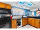 Modern kitchen with wood cabinets and black countertops at 311 69Th Ave. N # 101, Myrtle Beach, SC 29572