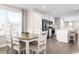 Open dining area with kitchen view and hardwood floors at 313 Bent Green Ct. # 84C, Murrells Inlet, SC 29576