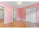 Pink bedroom with hardwood floors and a double door closet at 320 Muirfield Rd., Myrtle Beach, SC 29588