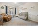 Serene bedroom with leather chair and a crib at 34 Pipedown Way, Pawleys Island, SC 29585