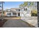 White two-story house with a charming front porch and attached garage at 34 Pipedown Way, Pawleys Island, SC 29585