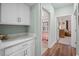 Light-filled hallway with linen closet and views into other rooms at 34 Pipedown Way, Pawleys Island, SC 29585