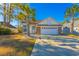 Attractive single-story house with a two-car garage and palm trees at 35 Easter Lilly Ct., Murrells Inlet, SC 29576