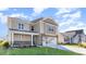 Two-story house with beige siding, stone accents, and a two-car garage at 382 Glacier Way, Conway, SC 29526