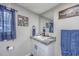 Bathroom with granite countertop, white vanity, and blue accents at 3845 Woodridge Circle, Little River, SC 29566