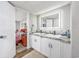 Modern bathroom with dual sinks, granite countertop, and a large lit mirror at 3845 Woodridge Circle, Little River, SC 29566