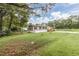 Tan mobile home with red shutters and green lawn at 3845 Woodridge Circle, Little River, SC 29566