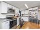 Modern kitchen with white cabinets, stainless steel appliances, and granite countertops at 3845 Woodridge Circle, Little River, SC 29566