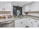 Kitchen with white cabinets, stainless steel appliances, and a double sink at 3845 Woodridge Circle, Little River, SC 29566