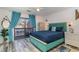 Bedroom with teal bed frame, private balcony access, and wood-look floors at 405 Garden Dr. # 106A, Surfside Beach, SC 29575