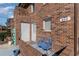 Brick building exterior with a blue bench and potted plants at 405 Garden Dr. # 106A, Surfside Beach, SC 29575