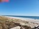 Oceanfront view with sandy beach and blue water at 417 S Dunes Dr., Pawleys Island, SC 29585