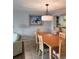 Spacious dining area with light wood table and chairs, and a stylish light fixture at 417 S Dunes Dr., Pawleys Island, SC 29585