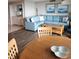 Bright living room with light blue sectional sofa, wood coffee table, and dining area at 417 S Dunes Dr., Pawleys Island, SC 29585