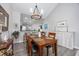 Cozy dining room featuring an adjacent eating area, chandelier, and hardwood floors at 4210 Coquina Harbour Dr. # A-16, Little River, SC 29566