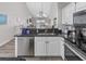 Close up of kitchen counter with stainless steel appliances and a view to the living area at 4210 Coquina Harbour Dr. # A-16, Little River, SC 29566