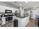 Modern kitchen with stainless steel appliances and island, flowing into the breakfast area at 4210 Coquina Harbour Dr. # A-16, Little River, SC 29566