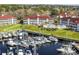 Beautiful waterfront condos overlooking a marina with many boats docked and a lovely green lawn at 4210 Coquina Harbour Dr. # A-16, Little River, SC 29566