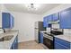 Modern kitchen with blue cabinets and granite countertops at 4243 Villa Dr. # 502, Little River, SC 29566