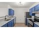 Modern kitchen with blue cabinets and granite countertops at 4243 Villa Dr. # 502, Little River, SC 29566