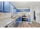 Modern kitchen with blue cabinets and granite countertops at 4273 Villas Dr. # 1006, Little River, SC 29566