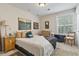 Cozy bedroom with a queen-size bed, window seating and tasteful artwork at 4323 Lotus Ct. # G, Murrells Inlet, SC 29576