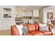 Orange leather couch and view into kitchen with white cabinets at 4323 Lotus Ct. # G, Murrells Inlet, SC 29576