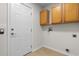 Laundry room with wood cabinets and a door to outside at 4387 Heartwood Ln., Myrtle Beach, SC 29579