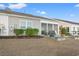 View of a backyard featuring a patio, plantings, and a sunroom overlooking a grassy area at 4451 Livorn Loop # 4451, Myrtle Beach, SC 29579