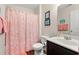 Cozy bathroom featuring wood-look flooring, framed art, and a sink with storage underneath at 4451 Livorn Loop # 4451, Myrtle Beach, SC 29579