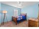 Bright and airy bedroom with light-blue walls, wood bed, and a ceiling fan at 4451 Livorn Loop # 4451, Myrtle Beach, SC 29579