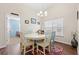 Bright dining room with a chandelier, wood floors and views into the adjacent blue bedroom at 4451 Livorn Loop # 4451, Myrtle Beach, SC 29579