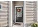 Dark-stained front door with wreath and welcome mat at 4451 Livorn Loop # 4451, Myrtle Beach, SC 29579