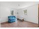 Simple bedroom with two windows, laminate flooring, and a blue couch at 45 Steve Carmichael Rd., Hemingway, SC 29554