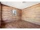 Simple bedroom with wood-paneled walls and hardwood flooring at 45 Steve Carmichael Rd., Hemingway, SC 29554