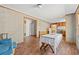 Simple dining area with table and chairs, hardwood floors, and view into kitchen at 45 Steve Carmichael Rd., Hemingway, SC 29554