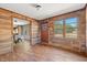 Bright entryway with wood-paneled walls, wood-look floors, and view to dining area at 45 Steve Carmichael Rd., Hemingway, SC 29554