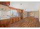 Kitchen with wood cabinets, double sink, and view into dining area at 45 Steve Carmichael Rd., Hemingway, SC 29554