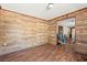 Spacious living room featuring wood-paneled walls and wood-look flooring at 45 Steve Carmichael Rd., Hemingway, SC 29554