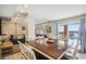 Dining area with a wooden table, chairs, and pool view at 4501 S Ocean Blvd., North Myrtle Beach, SC 29582