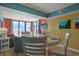 Bright dining area with table and chairs and ocean view at 4605 S Ocean Blvd. # E-1, North Myrtle Beach, SC 29582