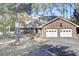 Brick home with a two-car garage and American flag at 47 Byers Trail, Pawleys Island, SC 29585