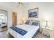 Bedroom with queen bed, ensuite bathroom, and water views at 4781 Wild Iris Dr. # 304, Myrtle Beach, SC 29577