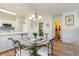 Casual dining area with glass-top table and chairs, offering views into kitchen and living room at 4781 Wild Iris Dr. # 304, Myrtle Beach, SC 29577