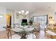 Open concept dining area with glass table and chairs, near living room and kitchen at 4781 Wild Iris Dr. # 304, Myrtle Beach, SC 29577