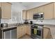 Bright kitchen with stainless steel appliances and granite counters at 4894 Luster Leaf Circle # 402, Myrtle Beach, SC 29577