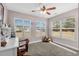 Bright bedroom with large windows, ceiling fan, and ample natural light at 518 Cordgrass Ln., Little River, SC 29566